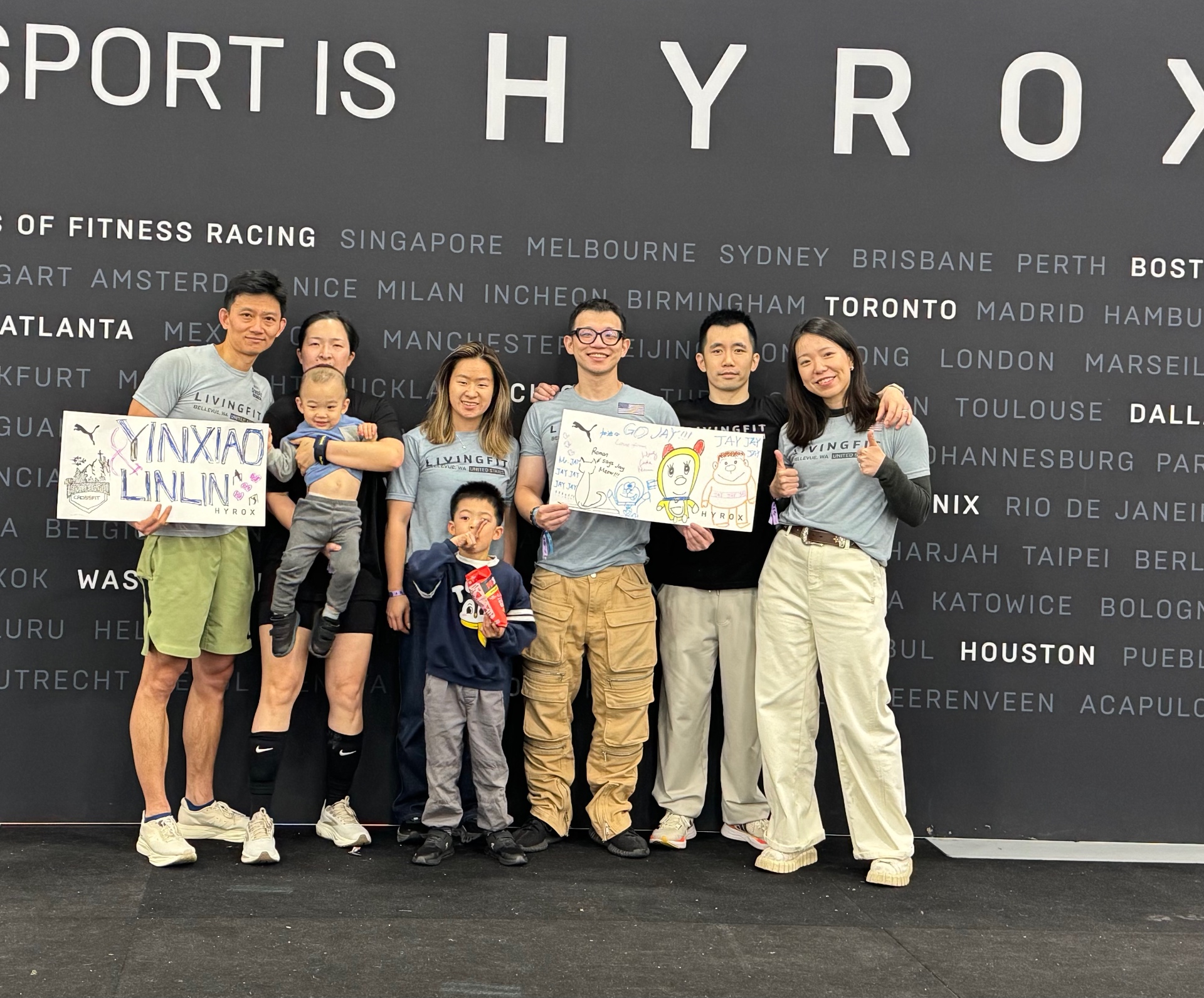 LivingFit team at HYROX with handmade signs and family